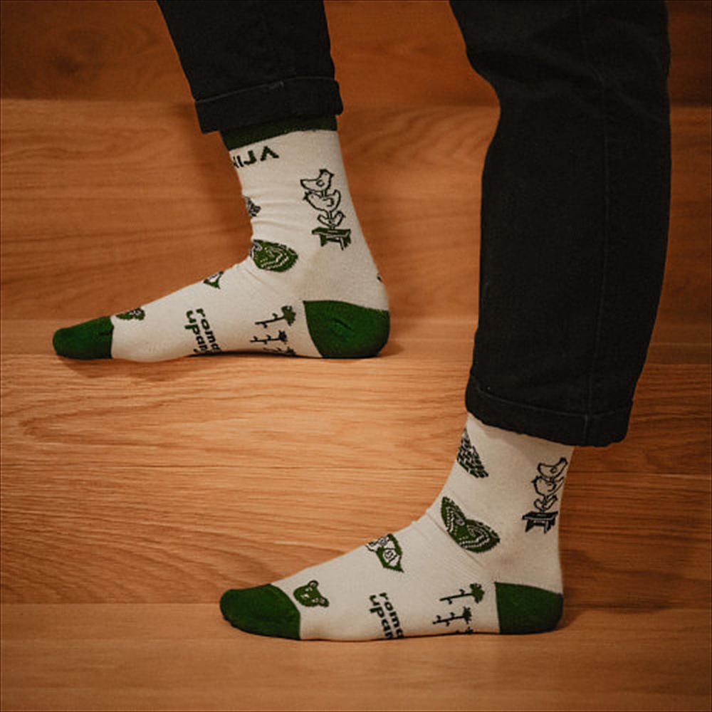 Socks with Slovenian illustrations, worn on wooden stairs